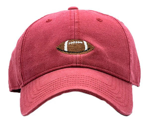 Football on Weathered Red Hat